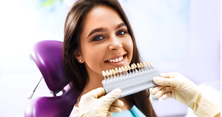 Smiling woman with artificial teeth